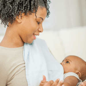Mother looking lovingly as her baby breastfeeds