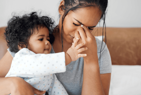 Tired Mum holding baby