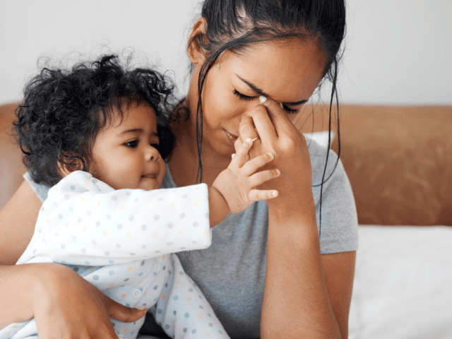 Tired Mum holding baby
