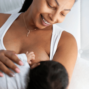 Mum breastfeeding baby and smiling down with love